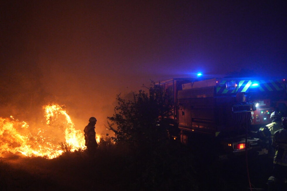 Firefighters tackling a wildfire in dry Mediterranean woodland