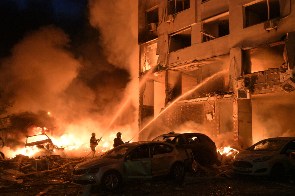 Emergency workers at a damaged residential building in Kyiv after Russian missile and drone strikes